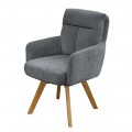 Designové skandinávské otočné jídelní křeslo Dover s žinylkovým potahem v šedé barvě se sametovým leskem s čalouněným opěrkovým polštářem s prošíváním ve tvaru T s hnědými šikmými nožičkami z bukového dřeva