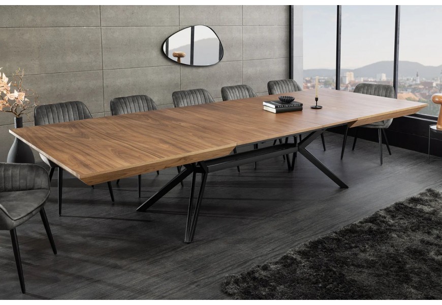Moderní industriální jídelní stůl Gerant s obdélníkovou vrchní deskou s možností rozložení z ořechové dýhy v naturální hnědé barvě s přirozenou kresbou letokruhů s podstavou z kovu v matném černém provedení se čtyřmi nohama