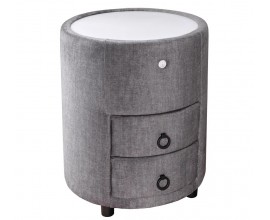 Designový čalouněný kulatý noční stolek Aluro s šedým potahem ze sametu se dvěma zásuvkami a nízkými černými nožičkami s bílou vrchní deskou s LED podsvícením
