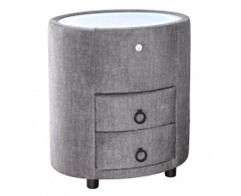Art deco čalouněný šedý noční stolek Aluro s potahem ze sametu se dvěma zásuvkami s bílou vrchní deskou se zabudovaným LED podsvícením oválného tvaru na nízkých černých nožičkách