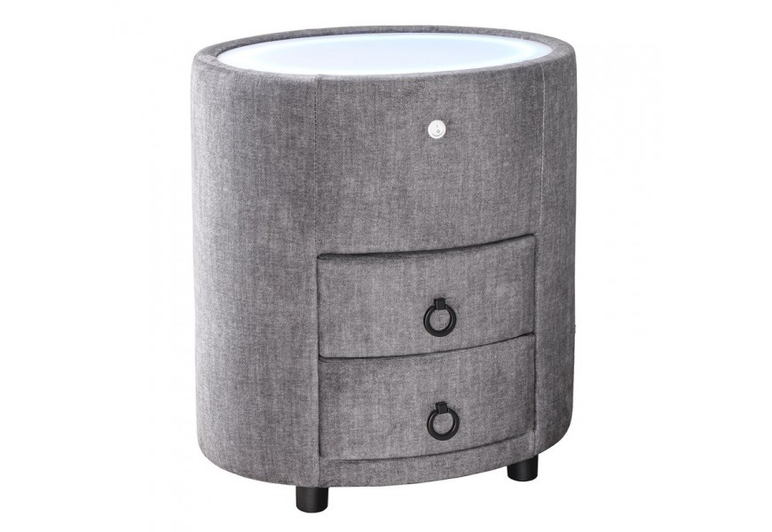 Art deco čalouněný šedý noční stolek Aluro s potahem ze sametu se dvěma zásuvkami s bílou vrchní deskou se zabudovaným LED podsvícením oválného tvaru na nízkých černých nožičkách