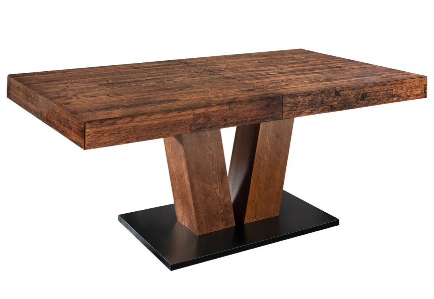 Masivní moderní obdélníkový jídelní stůl Sawyer ze dřeva v tmavě hnědé barvě s rustikální patinovanou povrchovou úpravou s rozkládací deskou se dvěma mohutnými zešikmenými nohami na obdélníkové podstavě v černé barvě