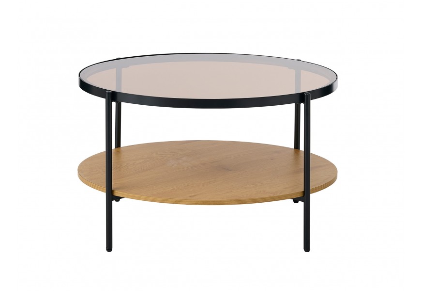 Skleněný retro konferenční stolek Sonny s kulatou vrchní průhlednou deskou s hnědým tónováním s kovovým rámem v černé barvě a policí z melaminové dýhy ve světlém hnědém dubovém provedení