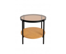 Industri&aacute;ln&iacute; př&iacute;ručn&iacute; stolek Sonny s kulatou deskou s t&oacute;novan&eacute;ho hněd&eacute;ho bezpečnostn&iacute;ho skla s melaminovou polic&iacute; ve světl&eacute;m hněd&eacute;m dubov&eacute;m proveden&iacute; s konstrukc&iacute; z kovu v matn&eacute; čern&eacute; barvě se čtyřmi nohama