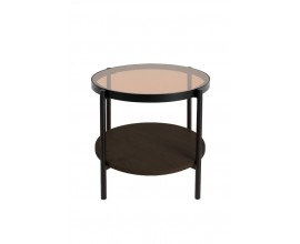 Industri&aacute;ln&iacute; kulat&yacute; př&iacute;ručn&iacute; stolek Sonny s kulatou průhlednou deskou z hněd&eacute;ho t&oacute;novan&eacute;ho skla s polic&iacute; z melaminov&eacute; d&yacute;hy v tmav&eacute;m hněd&eacute;m dubov&eacute;m proveden&iacute; s konstrukc&iacute; z kovu v čern&eacute; matn&eacute; barvě