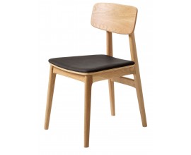 Skandin&aacute;vsk&aacute; masivn&iacute; j&iacute;deln&iacute; židle Vimo s konstrukc&iacute; z dubov&eacute;ho dřeva ve světle hněd&eacute; barvě se &scaron;ikm&yacute;ma nohama a zakřivenou opěrkou s čalouněn&yacute;m sedadlem s potahem z čern&eacute; ekokůže