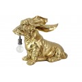 Stylová art deco stolní lampa Pop Atelier v atypickém tvaru psa jezevčíka ve zlaté barvě s dlouhýma ušima s prodlouženým tělem s krátkýma nohama s objímkou ​​v tlamě a dlouhým přívodním kabelem