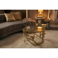Glamour zlat&yacute; kulat&yacute; konferenčn&iacute; stolek Tierra Glam s průhlednou skleněnou deskou a kovovou podstavou s designem kober 70 cm