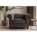 Designov&eacute; &scaron;ed&eacute; křeslo Chesterfield se sametov&yacute;m potahem s pro&scaron;&iacute;v&aacute;n&iacute;m s kulat&yacute;mi knofl&iacute;ky a zarolovanou opěrkou 109 cm