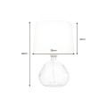 Modern&iacute; skleněn&aacute; stoln&iacute; lampa Glassy s asymetrickou transparentn&iacute; nohou a b&iacute;l&yacute;m textiln&iacute;m st&iacute;n&iacute;tkem 42 cm