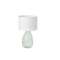 Moderní skleněná lampa Glassy s atypickou podstavou s průhledného bezpečnostního skla s asymetrickou siluetou s bílým kulatým textilním stínítkem