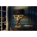 Designov&aacute; glamour stoln&iacute; lampa Tierra Glam se zlatou podstavou ve tvaru stoj&iacute;c&iacute; opice s čern&yacute;m obd&eacute;ln&iacute;kov&yacute;m st&iacute;n&iacute;tkem 65 cm