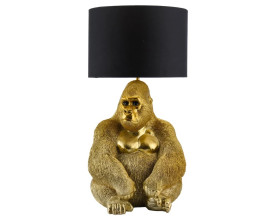 Art deco stoln&iacute; lampa Tierra Glam s podstavou se sochou sed&iacute;c&iacute; opice v leskl&eacute;m zlat&eacute;m proveden&iacute; s detaily srsti a obličeje s čern&yacute;m textiln&iacute;m st&iacute;n&iacute;tkem v&aacute;lcovit&eacute;ho tvaru