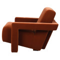Luxusn&iacute; art deco křeslo Phineas s celoplo&scaron;n&yacute;m potahem ve sp&aacute;len&eacute; oranžov&eacute; barvě s designov&yacute;mi geometrick&yacute;mi opěrkami 75 cm