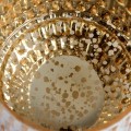 Large gold and white patterned candle holder.