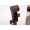 Masivní stylová vinotéka Braley ve tvaru violoncella hnědé barvy s deseti přihrádkami na víno 135cm