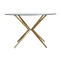Luxusní Art-Deco kulatý jídelní stůl Sursee s překříženými zlatými nožičkami a skleněnou vrchní deskou 121cm