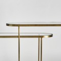 Art-deco set oválných konzolových stolků Amuny se skleněnou deskou a kovovou konstrukcí ve zlaté barvě 91cm