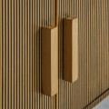 Art deco glamour ovální TV stolek Chamoix ve zlatém provedení s kovovou konstrukcí a černou mramorovou deskou 180cm