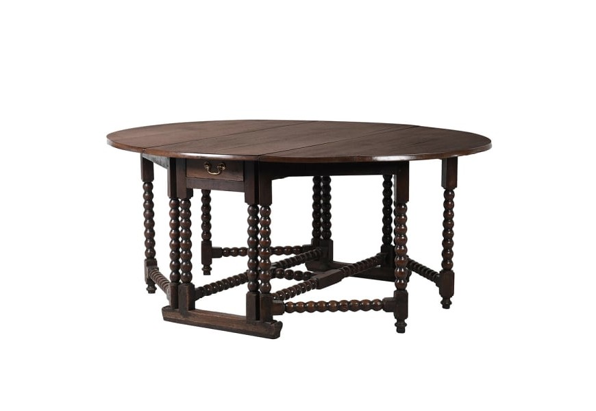 Dřevěný kulatý jídelní stůl Azrael tmavě hnědé barvy se sklápěcí deskou a praktickými zásuvkami