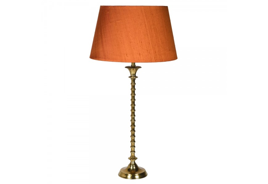 Stylová vintage stolní lampa Impala s ozdobnou kovovou podstavou zlaté barvy as oranžovým stínítkem