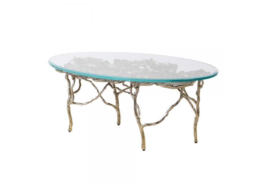 Art deco konferenční stolek Lily s oválnou vrchní deskou z temeprovaného skla na kovové konstrukci na nožičkách s listy leknínu ve zlaté lesklé barvě