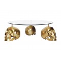 Designový kulatý konferenční stolek Hamlet se třemi nožičkami ve tvaru lebek ve zlaté barvě a skleněnou vrchní deskou 90 cm
