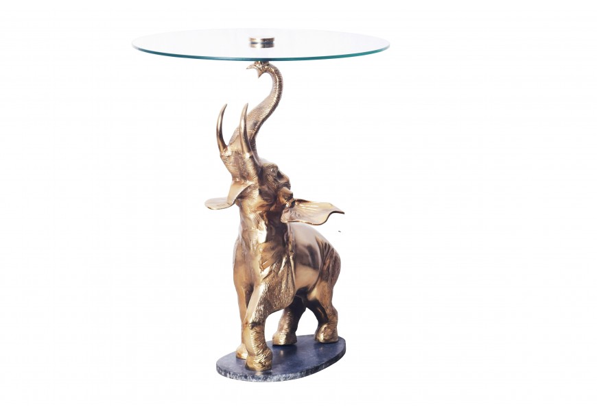 Designový art deco kulatý příruční stolek Balarama s podstavou ve tvaru slona ve zlaté barvě na oválném mramorovém podstavci s vrchní deskou z bezpečnostního skla
