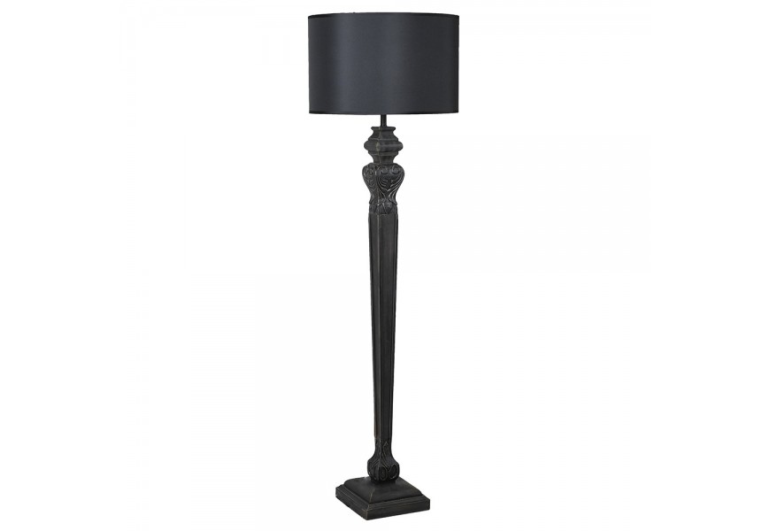 Designová vintage černá stojací lampa Samir s oválným textilním stínítkem a vyřezávanou vysokou úzkou nohou s vyřezávaným motivem andělských křídel