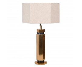 Designová art deco stolní lampa Anasa s kovovou podstavou v lesklé zlaté barvě šestiúhelníkového tvaru a textilním lněným stínítkem ve světlé béžové barvě ve tvaru šestiúhelníku