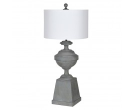 Vintage šedá stolní lampa Gaia s kulatým bílým textilním stínítkem a designovou nohou s kulatým centrálním prvkem na vyvýšeném hranatém podstavci s nátěrem s popraskaným efektem