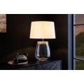 Stylov&aacute; skleněn&aacute; stoln&iacute; lampa Clasico s nohou v podobě průsvitn&eacute; n&aacute;doby s v&aacute;lcov&yacute;m b&eacute;žov&yacute;m st&iacute;n&iacute;tkem 60 cm