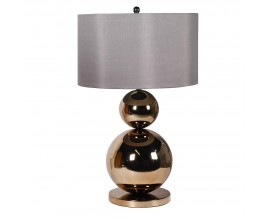 Designová glamour noční lampa Leman s nohou z kovu ve zlaté barvě v podobě dvou koulí a kulaté podstavy as válcovým šedým stínítkem
