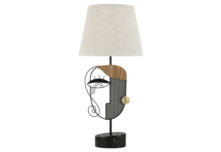 Industriální stolní lampa Donna s kovovou podstavou v černé barvě a béžovým stínítkem zdobená abstraktním uměleckým motivem obličeje s kovovými detaily