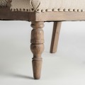 Luxusní provensálské čalouněné krémové křeslo Norod s vybíjenými nýty se vzorem a masivními hnědými nožičkami 75 cm