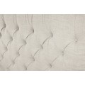 Stylová chesterfield čalouněná béžová manželská postel Kreon se lněným texturovaným potahem s nízkými černými nožičkami 220 cm