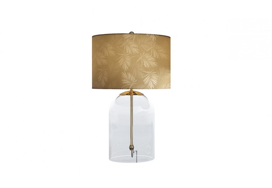 Glamour zlatá skleněná stolní lampa Gambier s průhlednou nohou ve tvaru zvonu se zlatou kovovou konstrukcí a kulatým textilním stínítkem s asymetrickým motivem palmových listů v odstínech zlaté