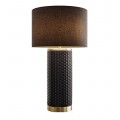Designová art deco keramická stolní lampa Draconia s černým kulatým textilním stínítkem a válcovitou nohou s geometrickým obdélníkovým reliéfním vzorem se zlatými kovovými detaily