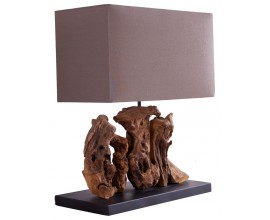 Rustikální stolní lampa s obdélníkovým textilním stínítkem v hnědé barvě a dekorativní podstavou z naplaveného dřeva.