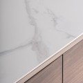 Luxusní designová oválná hnědá komoda Grisham se šesti šuplíky a bílou mramorovou deskou a černou podstavou 140 cm