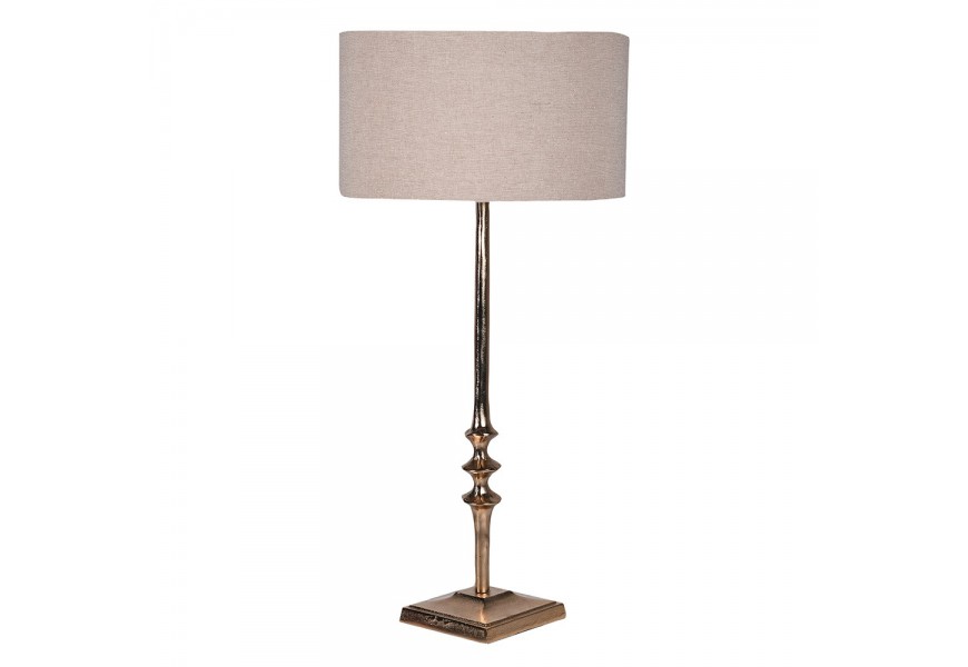 Vintage stolní lampa Aureum ze zlato zbarvené kovové podstavy se strukturovanými výběžky a béžovým lněným válcovým stínítkem