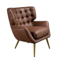 Luxusní art deco kožené hnědé křeslo Sayron se zádovou opěrkou s prošíváním v chesterfield stylu kovovými šikmými nožičkami v lesklém zlatém provedení