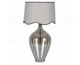 Moderní skleněná chromová stolní lampa Silivano s průhlednou lesklou nohou s hnědým tónováním a kovovou konstrukcí s šedým kulatým textilním stínítkem s černým lemováním a zvlněnou spodní částí