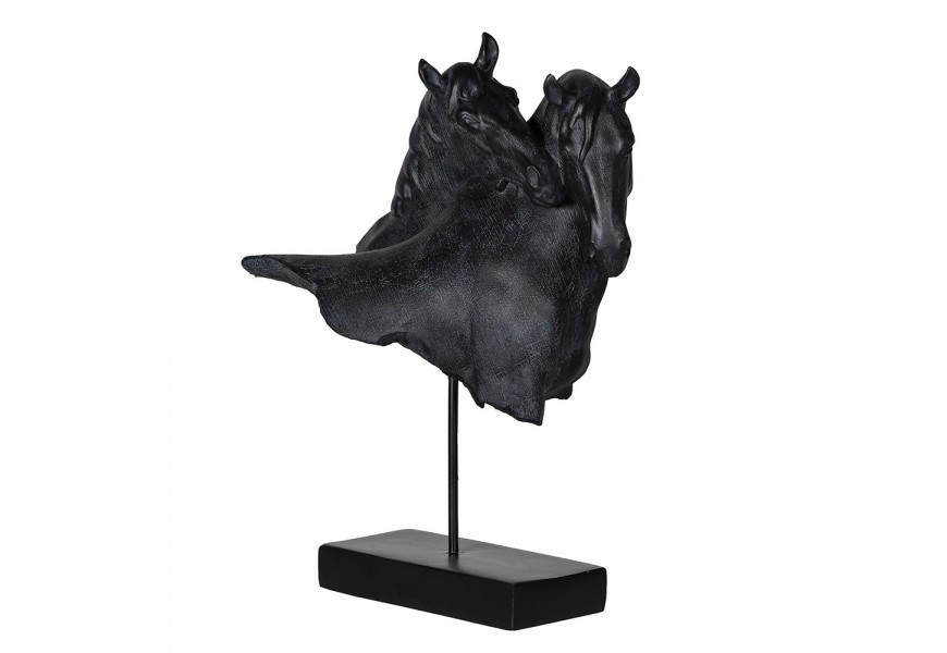 Designová socha Gerant v podobě dvou hlav koní v černé barvě se vzhledem kamene s podstavou v obdélníkovém tvaru