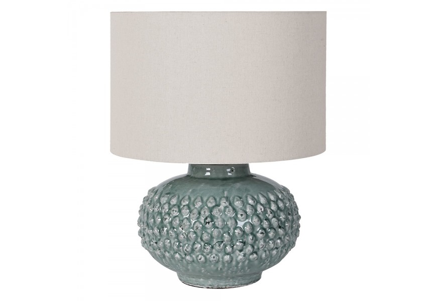 Designová keramická stolní lampa Gladis s kulatou keramickou podstavou s reliéfními kulatými výběžky v pastelové tyrkysově modré barvě s lesklou glazurou s kulatým stínítkem s lněné textilie v bílé barvě Designová keramická stolní lampa Gladis s kulatou keramickou podstavou s reliéfními kulatými výběžky v pastelové tyrkysově modré barvě s lesklou glazurou s kulatým stínítkem s lněné textilie v bílé barvě